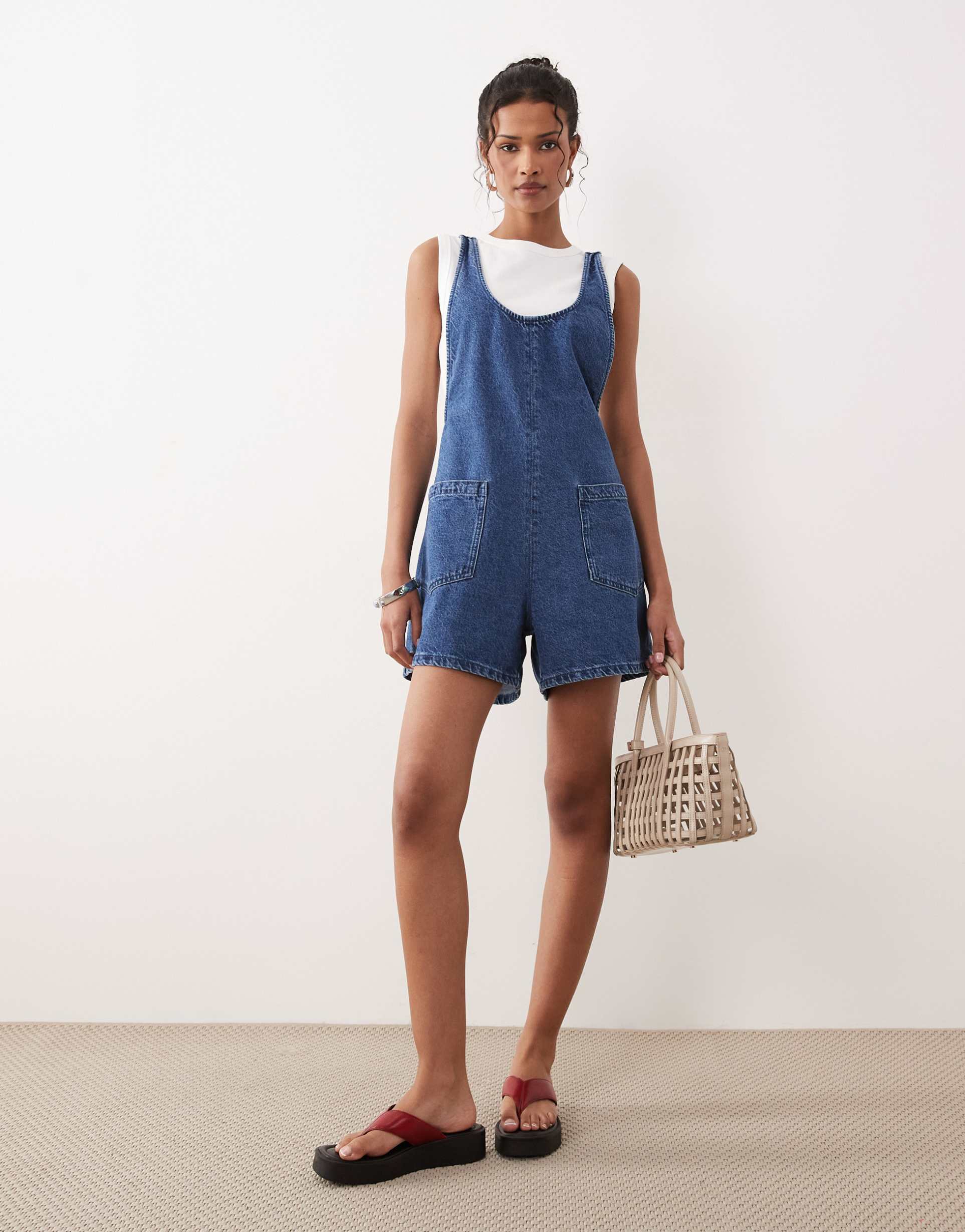 asos design denim playsuit with scoop neck and cross back in dark mid blue