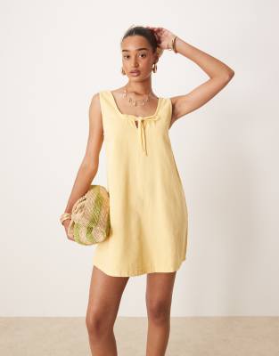 ASOS DESIGN denim scoop mini dress with bow front in buttermilk