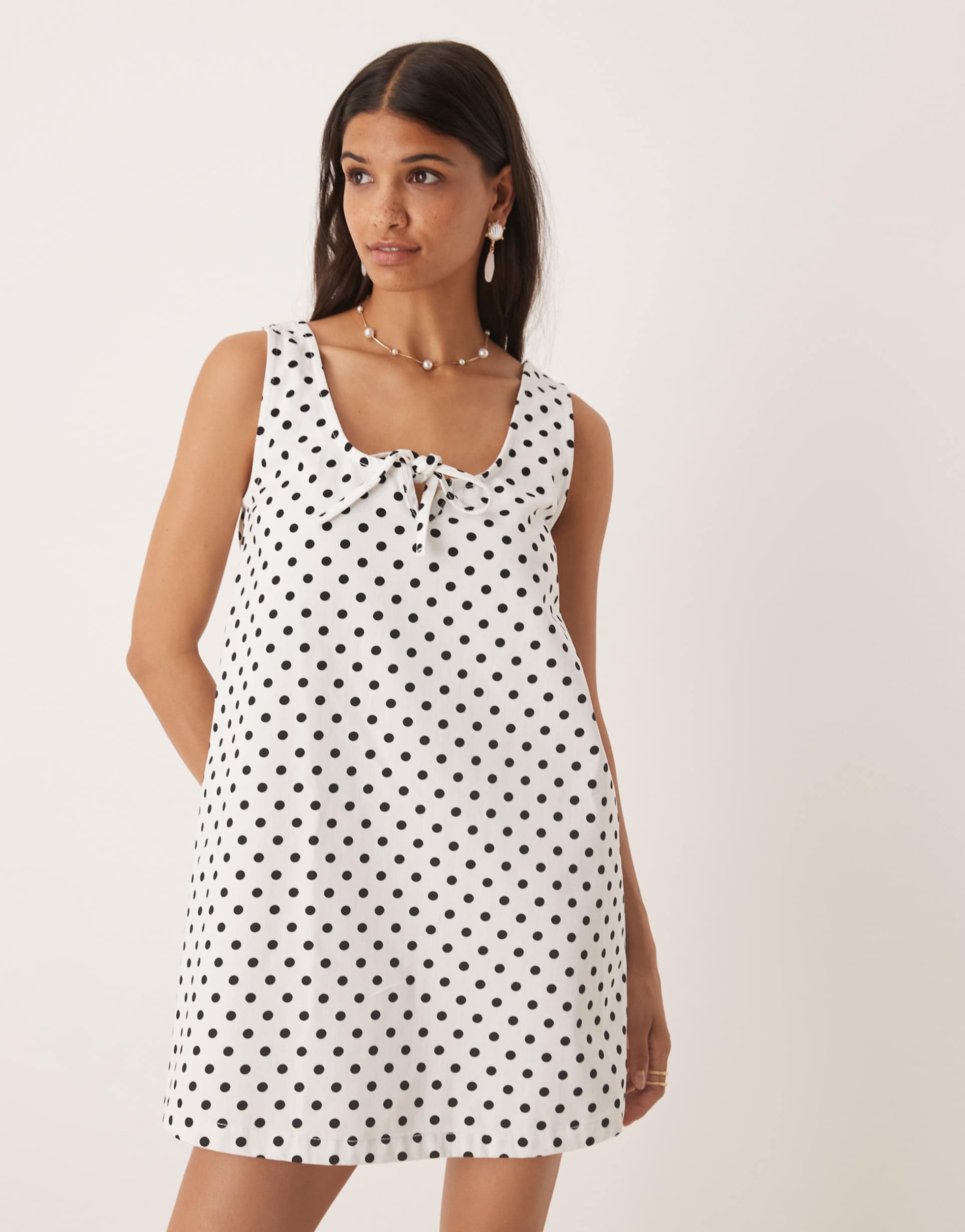 asos design denim scoop mini dress with bow front in polka dots