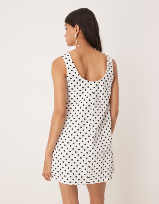ASOS DESIGN denim scoop mini dress with bow front in polka dots