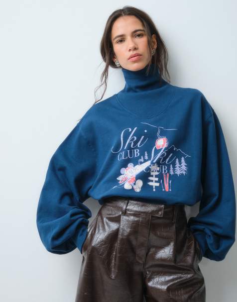 ASOS DESIGN Disney high neck jumper with Mickey Mouse ski club print in navy - view 1