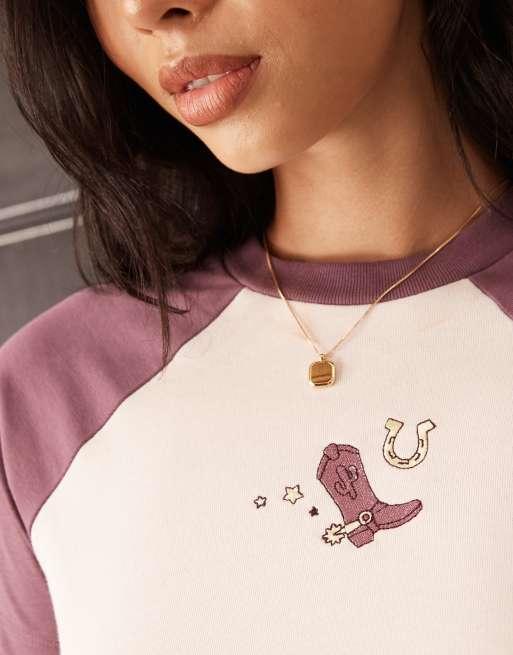 ASOS DESIGN Disney Pixar cropped t-shirt with Toy Story's Jessie embroidered print in baby pink