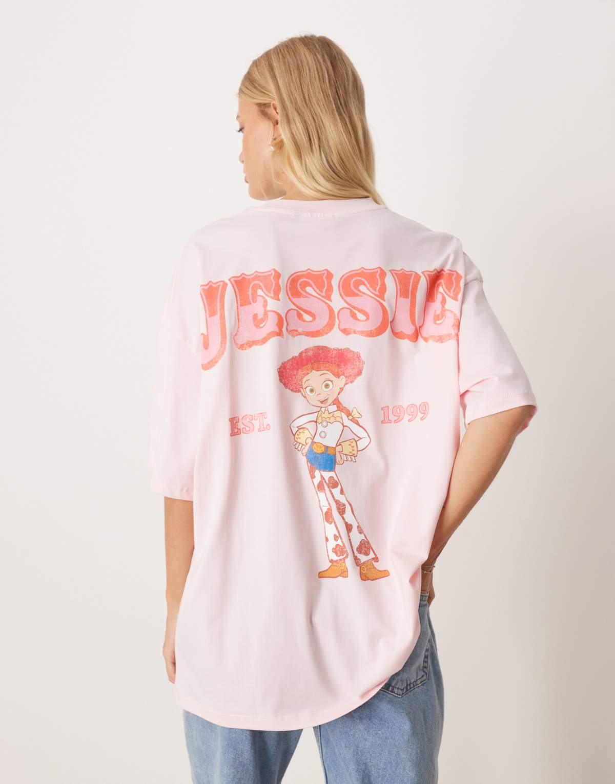 ASOS DESIGN Disney Pixar unisex oversized t-shirt with Toy Story Jessie prints in pink - LPINK