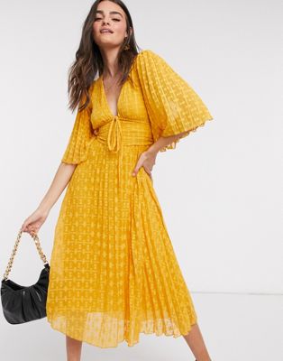 ASOS DESIGN dobby midi dress with lace up and fluted sleeves in mustard ...