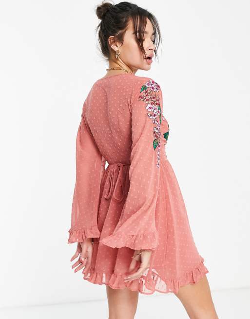 ASOS DESIGN dobby wrap mini skater dress with frills and floral embroidery  in peach | ASOS