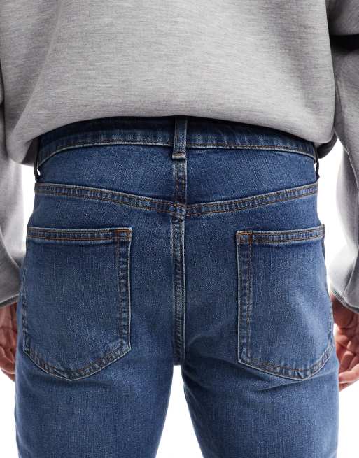 ASOS DESIGN – Dopasowane ciemnoniebieskie jeansy z efektem sprania, 4 z 5