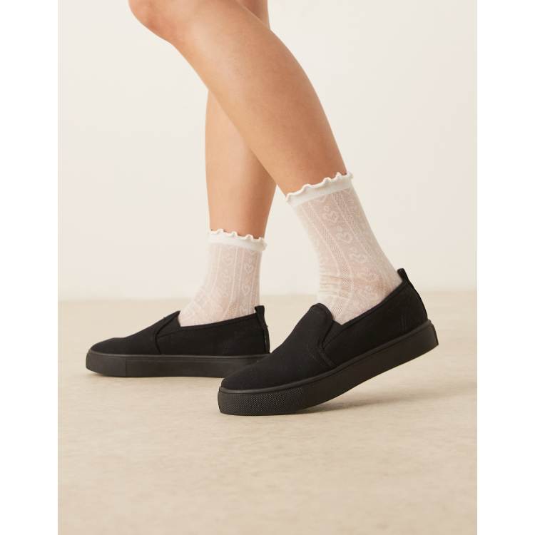 ASOS DESIGN Dotty slip on plimsolls in black