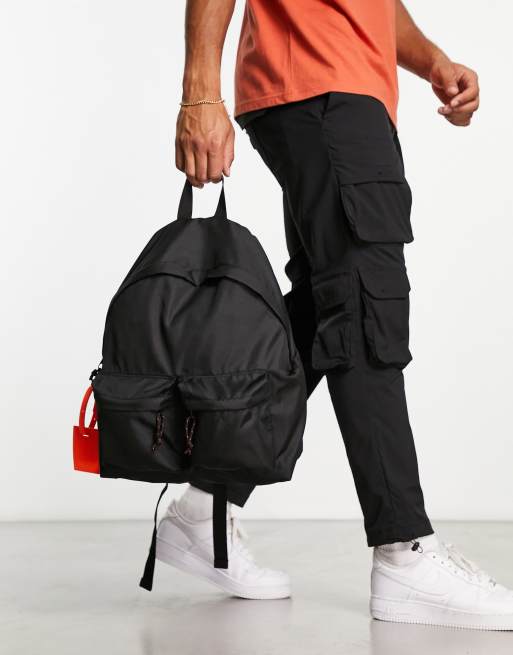 ASOS DESIGN double pocket backpack with orange luggage tag in black