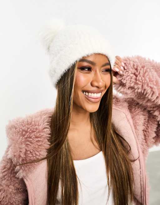 Cream hat with store fur pom pom