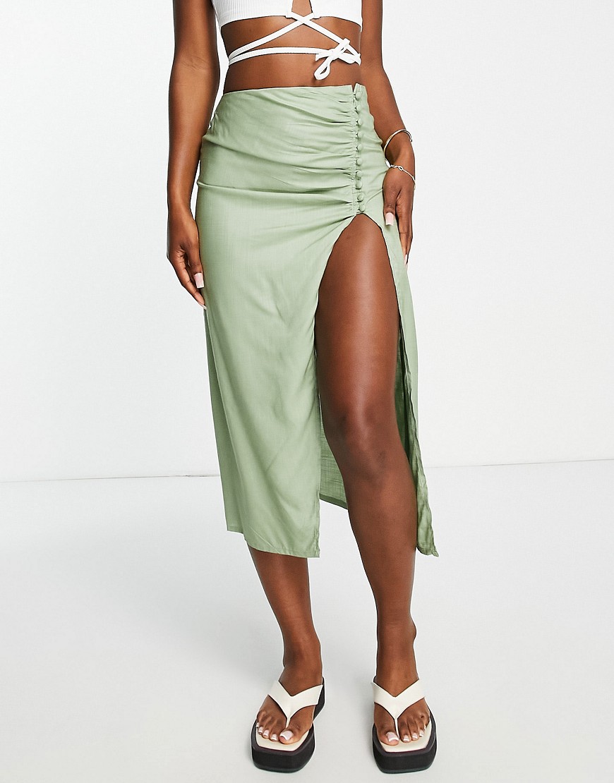 ASOS DESIGN drapey button side thigh slit midi skirt in sage green