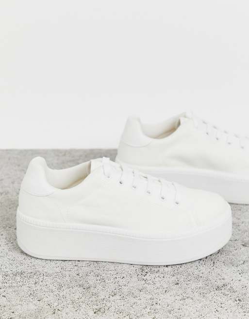 ASOS DESIGN sneakers in white with translucent blue sole