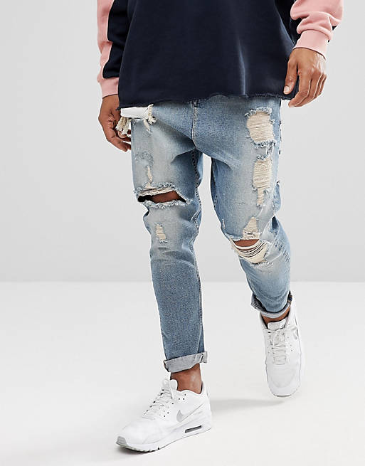 ASOS DESIGN drop crotch jeans in vintage light wash blue with heavy rips