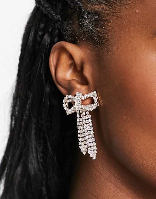 ASOS DESIGN drop earrings with crystal drench bow design in gold tone