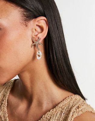 ASOS DESIGN drop earrings with sea shell design in gold tone