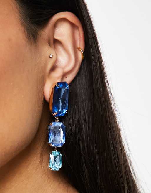 ASOS DESIGN drop earrings with tonal blue crystal drop in gold tone