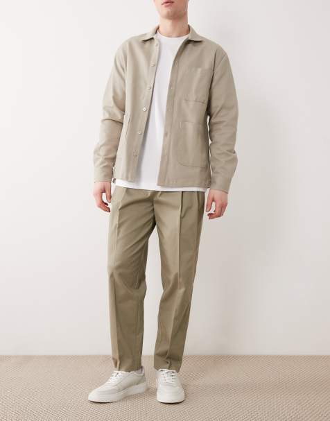 ASOS DESIGN – Eleganckie spodnie chinosy o luźnym kroju ze zwężanymi nogawkami i zakładkami z przodu w kolorze khaki z dużą zawartością bawełny - view 1