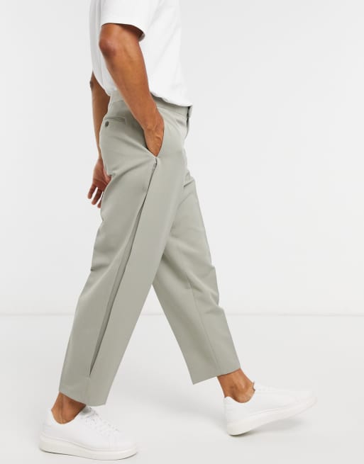 ASOS DESIGN – Eleganckie spodnie o kroju oversize ze zwężanymi nogawkami, ozdobnymi zaszewkami i mankietami