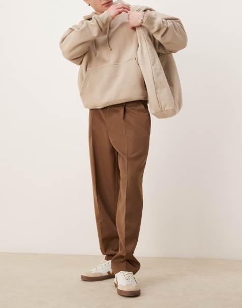 ASOS DESIGN – Elegante, schmal zulaufende Oversize-Hose in Braun mit Bundfalten - view 1