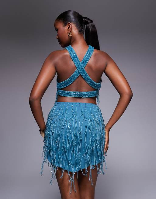 ASOS DESIGN embellished halter mini dress with cut-out waist and pointed hem in blue