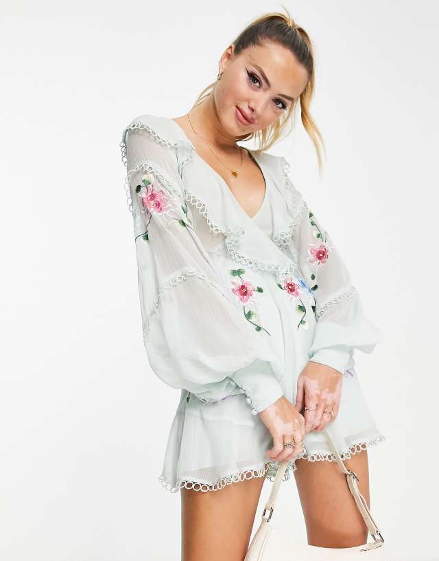 ASOS DESIGN embroidered textured cut-out romper with ruffle wrap in pale blue