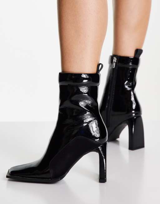 ASOS DESIGN Enchant high heeled padded boots in black patent