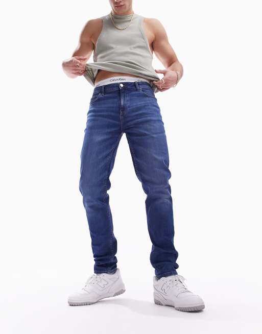 ASOS DESIGN – Eng geschnittene Jeans in dunkelblauer Waschung