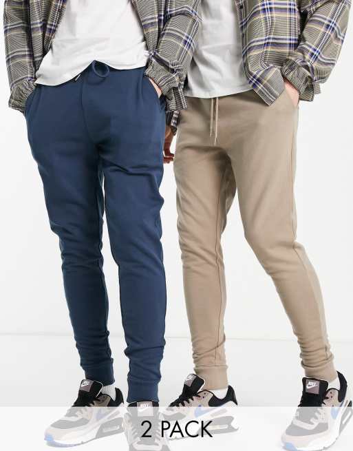 ASOS DESIGN – Eng geschnittene Jogginghosen in Beige und Marineblau im 2er-Pack