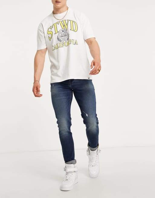 ASOS DESIGN – Enge Jeans in dunkler Waschung mit Abnutzungen 