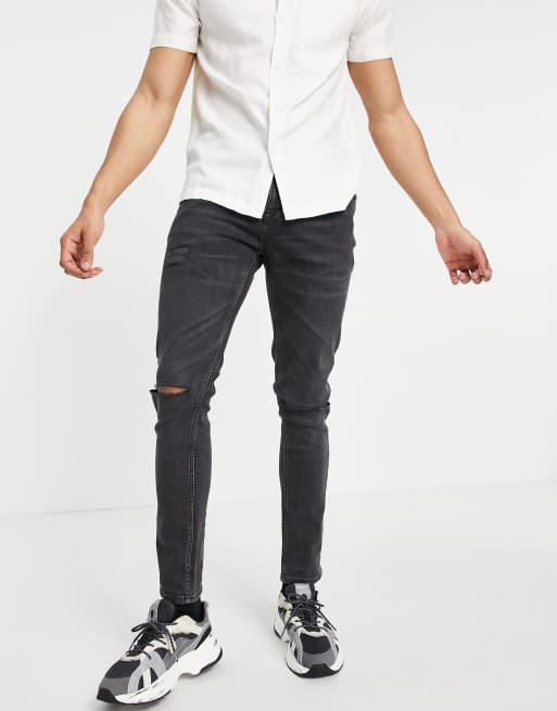 ASOS DESIGN – Enge Jeans mit Zierrissen am Knie in verwaschenem Schwarz