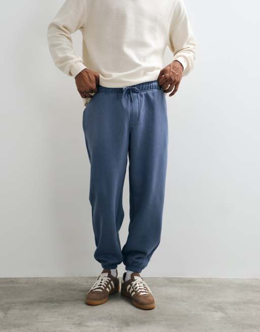 ASOS DESIGN essentials joggersy ze ściągaczami w kolorze niebieskim, 1 z 5