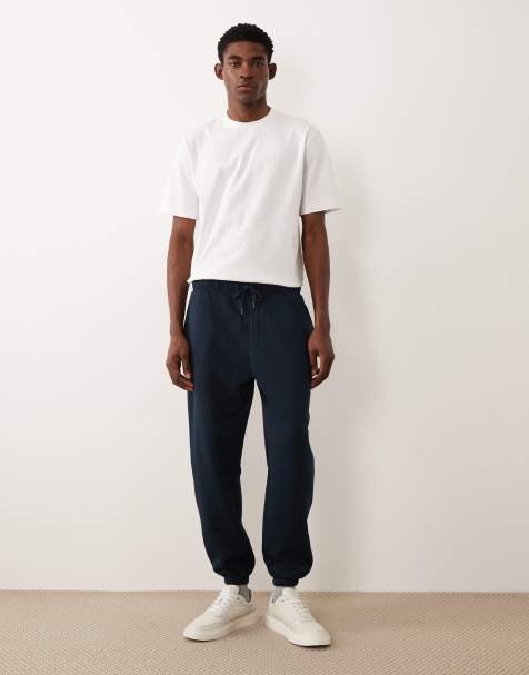ASOS DESIGN essentials tapered trackies in navy - view 1