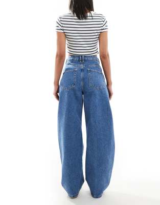 ASOS DESIGN extreme barrel leg jeans with button placket detail in mid blue