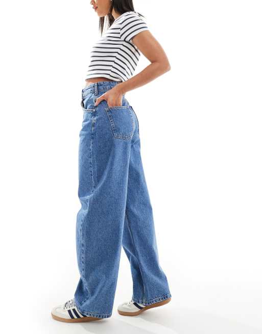 ASOS DESIGN extreme barrel leg jeans with button placket detail in mid blue