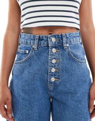 ASOS DESIGN extreme barrel leg jeans with button placket detail in mid blue