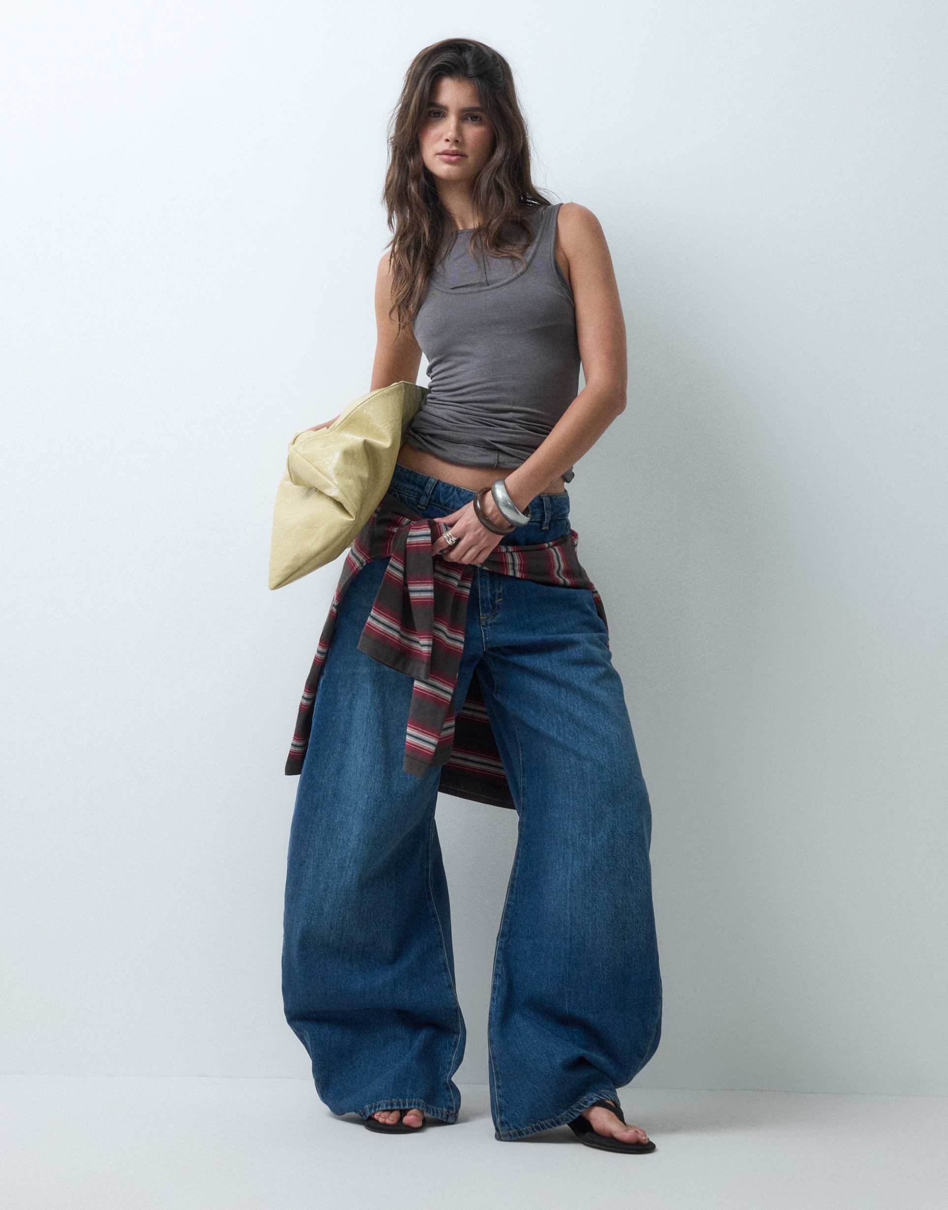 asos design extreme curved leg jeans in mid blue wash