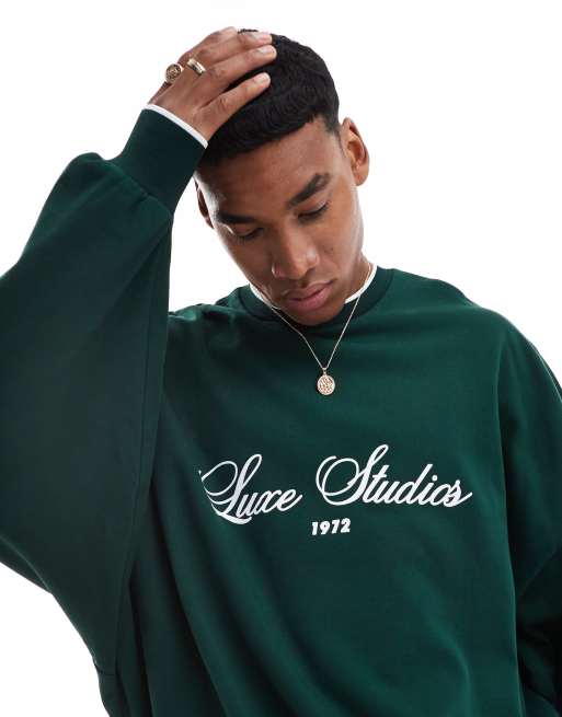 ASOS DESIGN extreme oversized crew neck sweatshirt with text print in dark green