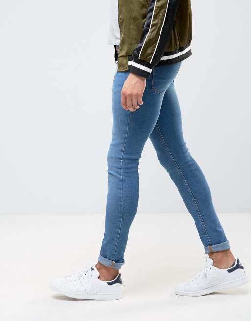 ASOS DESIGN super skinny jeans in mid wash blue with abrasions