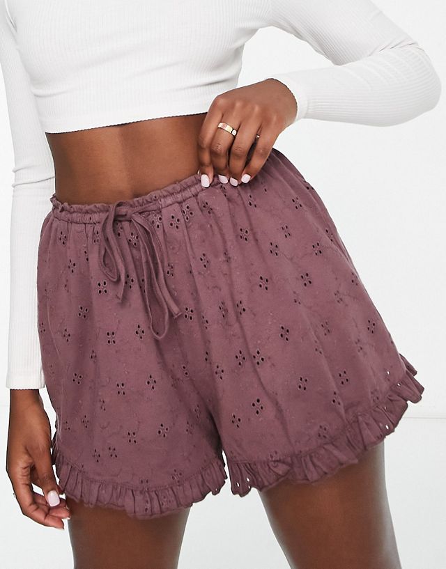 ASOS DESIGN eyelet short with ruffle hem and tie waist in brown