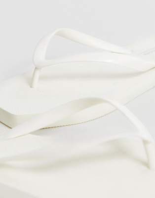 white cloth flip flops