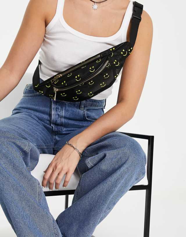 ASOS DESIGN fanny pack in organza with happy face embroidery in black