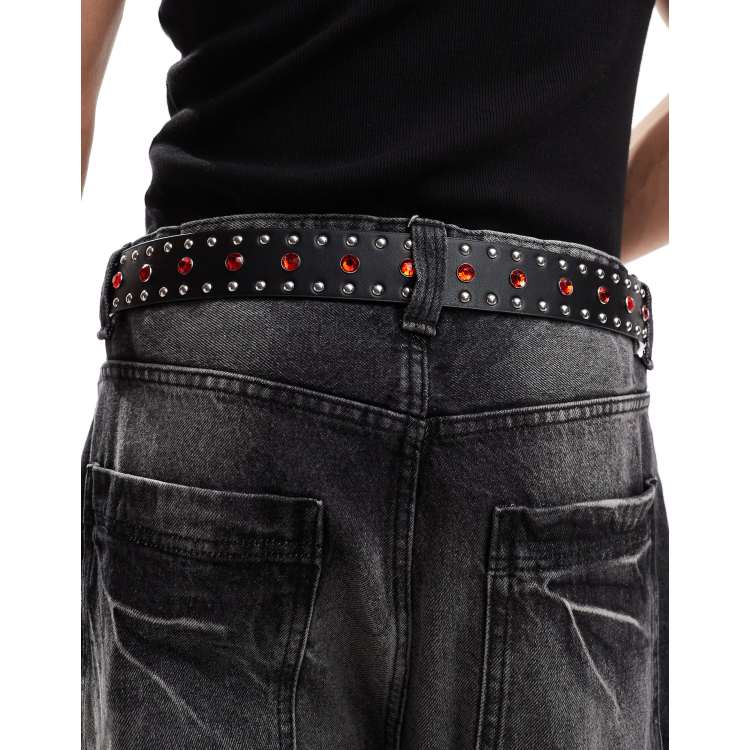 ASOS DESIGN faux leather belt with red crystals and studs in black
