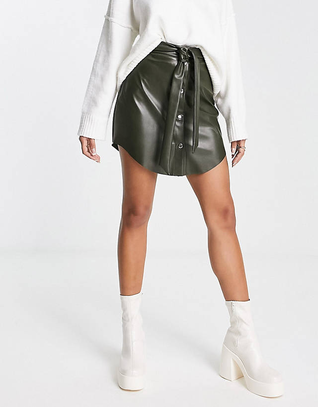 ASOS DESIGN - faux leather button through mini skirt with belt in khaki