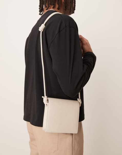 ASOS DESIGN faux leather cross body bag with strap detail in ecru - view 1