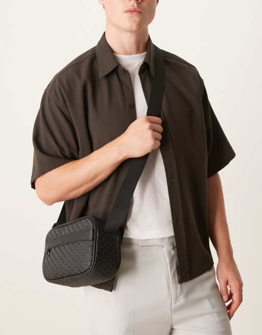 ASOS DESIGN faux leather crossbody bag with monogram detail in black