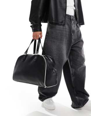 faux leather duffle bag in black with white contrast piping