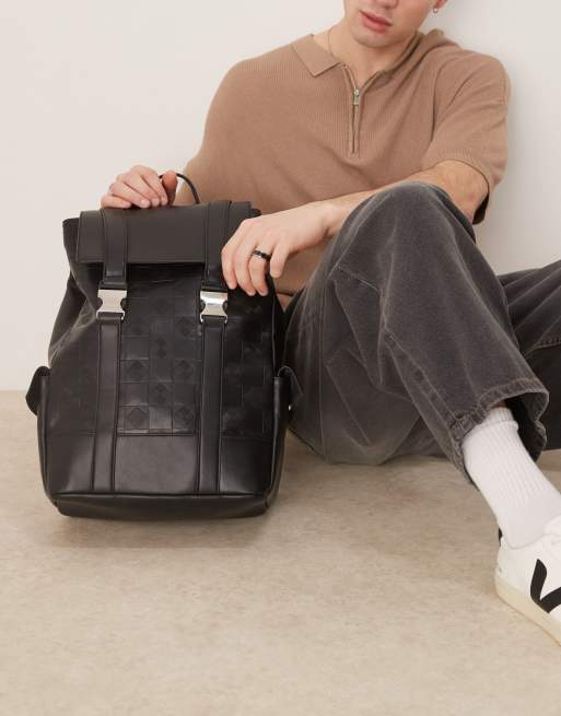 asos backpack in grain faux leather ASOS DESIGN faux leather monogram backpack in black
