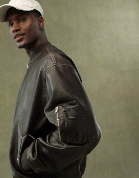 ASOS DESIGN faux leather oversized distressed bomber jacket in brown - view 1