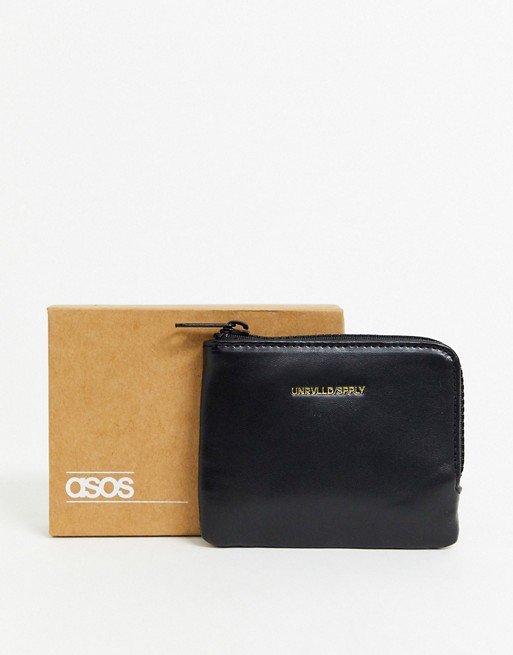 ASOS DESIGN Unrivalled Supply zip around wallet in black faux leather with branded emboss