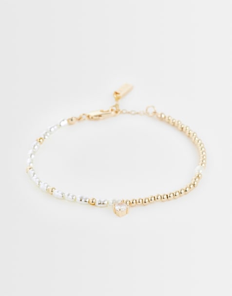 ASOS DESIGN faux pearl and bead bracelet in gold - view 1