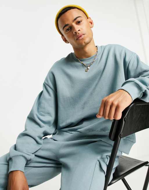 ASOS DESIGN - Felpa corta blu con pratica tasca in coordinato 